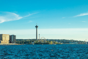 Fototapeta na wymiar Tampere, Finland - 24 June 2019: Sarkanniemi amusement park with Nasinneula tower, view over the water at sunset