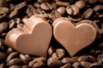 Chocolate hearts on a coffee beans pile