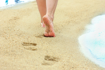 beautiful footprints in the sand by the sea background