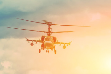 Military combat helicopter flies hangs in the air.