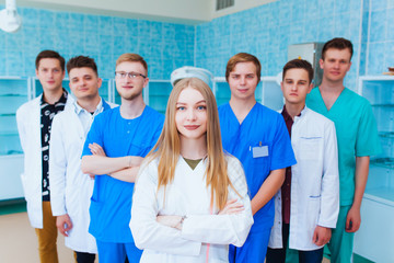 Medical students profession staff. multinational people - doctor, nurse and surgeon. A group of graduates of a medical university in a surgical room.