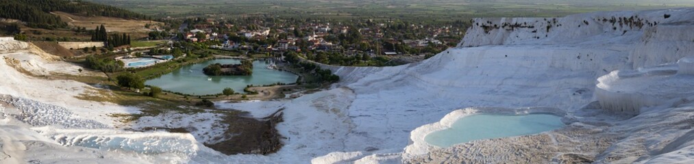 Fototapeta na wymiar Turkey, aerial view of the travertine terraces at Pamukkale (Cotton Castle), natural site of sedimentary rock deposited by water from hot springs, famous for carbonate mineral left by flowing water