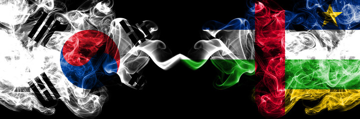 South Korea vs Central African Republic smoky mystic flags placed side by side. Thick colored silky abstract smoke flags of South Korean and Central African Republic