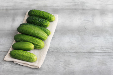 Farm cucumbers on wooden background. Close-up, copy space.