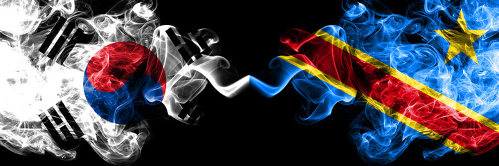 South Korea vs Democratic Republic of the Congo smoky mystic flags placed side by side. Thick colored silky abstract smoke flags of South Korean and Democratic Republic of the Congo
