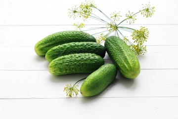 Farm cucumbers on wooden background. Close-up, copy space.
