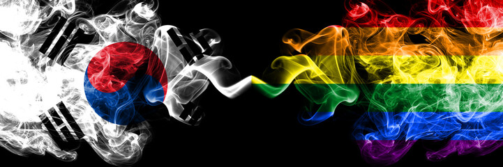 Fototapeta premium South Korea vs Gay pride smoky mystic flags placed side by side. Thick colored silky abstract smoke flags of South Korean and Gay pride