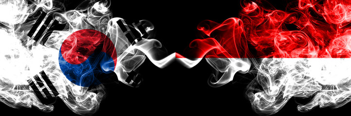 South Korea vs Indonesia, Indonesian smoky mystic flags placed side by side. Thick colored silky abstract smoke flags of South Korean and Indonesia, Indonesian