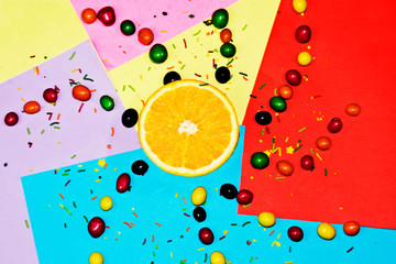 Orange slice among caramel on bright backgrounds
