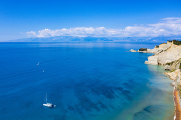Aerial view of beautiful green rocky Island. Rocky cliffs in the ocean seen from above.. 