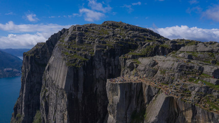 Preikestulen Norway. People enjoy the view from the mountain. July 2019.
