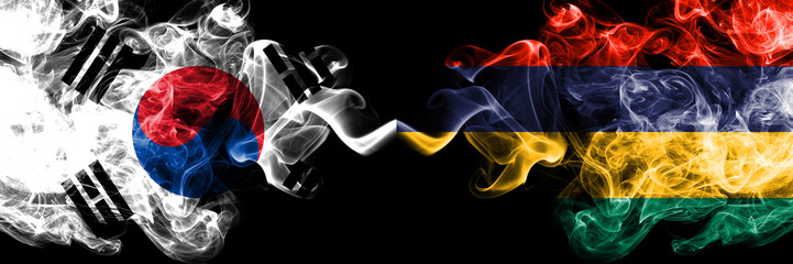 South Korea vs Mauritius, Mauritian smoky mystic flags placed side by side. Thick colored silky abstract smoke flags of South Korean and Mauritius, Mauritian