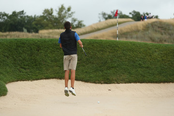 jumping from a sand bunker for a better view