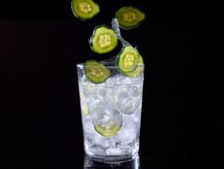 Cucumber water on black background.