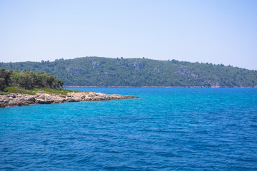 Naklejka premium Aegean Islands on mountains and blue sky background, Turkey. Tropical wallpaper, paradise beach