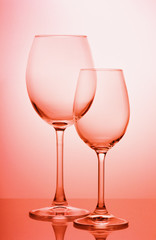 two wine glasses on a colored gradient background