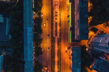Night city. Illuminated city street or road with car traffic in, aerial top view