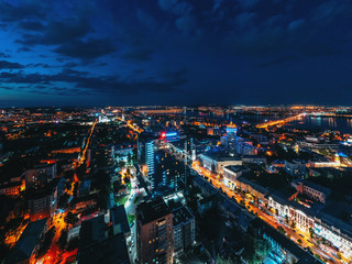 Night Voronezh city midtown or center aerial panorama from above, city after sunset with illuminated roads and traffic
