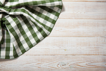 Obraz premium Napkin on white wooden table. Mock up for design. Top view.