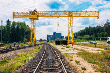 Fototapeta na wymiar Overhead crane and railway for sheet metal transportation in a factory