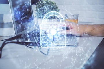 Multi exposure of lock icon with man working on computer on background. Concept of network protection.