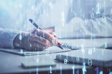 Multi exposure of writing hand on background with data technology hologram. Concept of innovation.