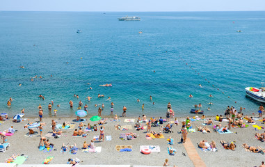Tourists relax on vacation at the Central beach in Yalta