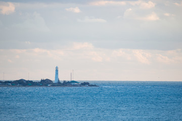 Old lighthouse stands on the sea in the evening