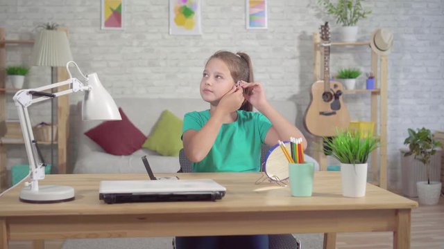 hard of hearing teen girl with hearing aid in ear