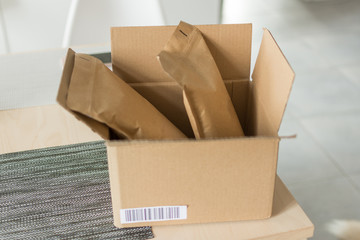 Opened cardboard over modern interior. Paper parcel opened indoors. Online shopping concept.
