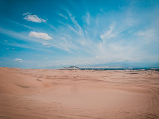 Connect with nature and tourism. Arid desert that connects with a blue sky and sand. 