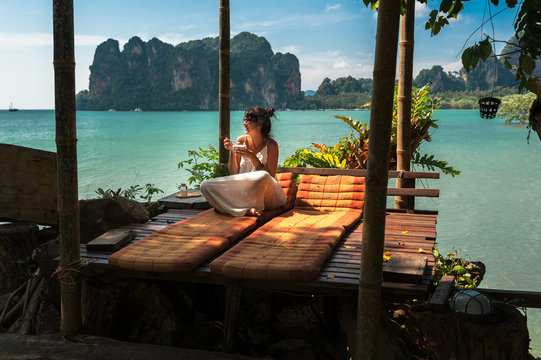 Beautiful girl resting on the sea. Lonely woman resting on the island. The girl on the Paradise coast. The girl on the Islands. A woman on a luxurious shore. Asian Islands. Holidays in Thailand