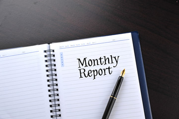 Notebook with fountain pen written word Monthly Report
