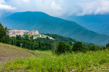View of the hotel complex in the mountains covered with green forests