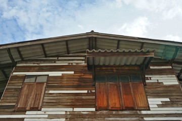 Fototapeta na wymiar Residential wooden houses and the sky backdrop in Thailand