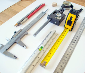 Measuring instruments and tools insulated on a white sheet. Set with various rulers, planimeter,...