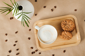 morning cappuccino with oatmeal cookies and coffee beans