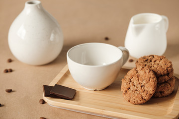white cup and american cookies on a white napkin