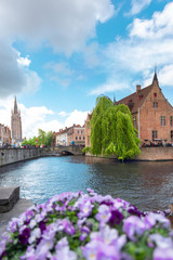 Fototapeta na wymiar Panoramic city view with Belfry tower and famous canal in Bruges, Belgium.