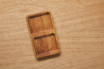 top view of wooden empty plate on wooden table