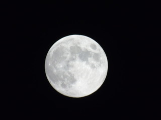 An amazing photography of the full moon over the city of Genova by night with a great clear sky in background and some stars