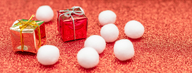 Christmas gift boxes on a red shiny background