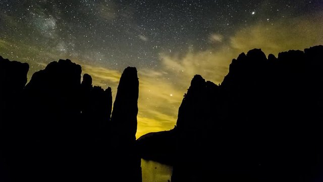 Night timelapse of the Milky Way rising over the rock formations of Serra de Finestres in Aragon, Spain