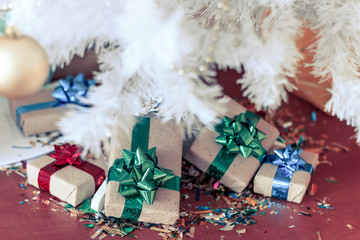 Various Christmas presents under the Christmas tree.
