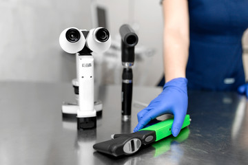 Professional equipment of a veterinary doctor ophthalmologist - manual slit lamp, ophthalmoscope, veterinary tonometer..Blurred Background