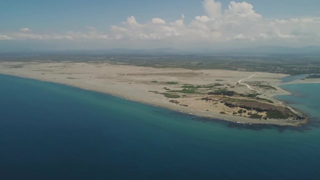 Aerial view of seashore with beaches, lagoons and coral reefs. Philippines, Luzon, Ilocos Norte. Coast ocean with turquoise water. Tropical landscape in Asia.