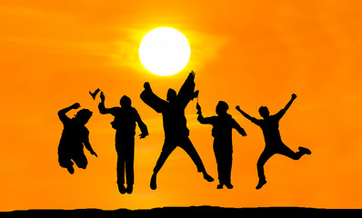 Silhouette of happy people jumping over sunset, concept about having fun