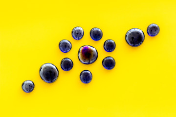 Glass stones for design and home creativity on yellow background top view space for text