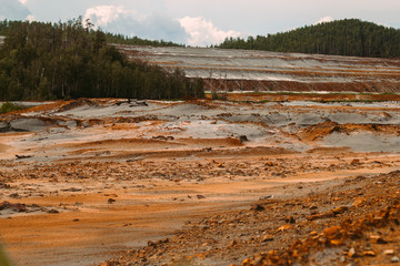 landscape with red soil polluted copper mining factory in Karabash, Russia, Chelyabinsk region, the dirtiest city on Earth