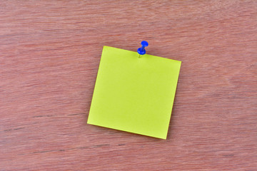 Single blank note paper attached to a wooden wall